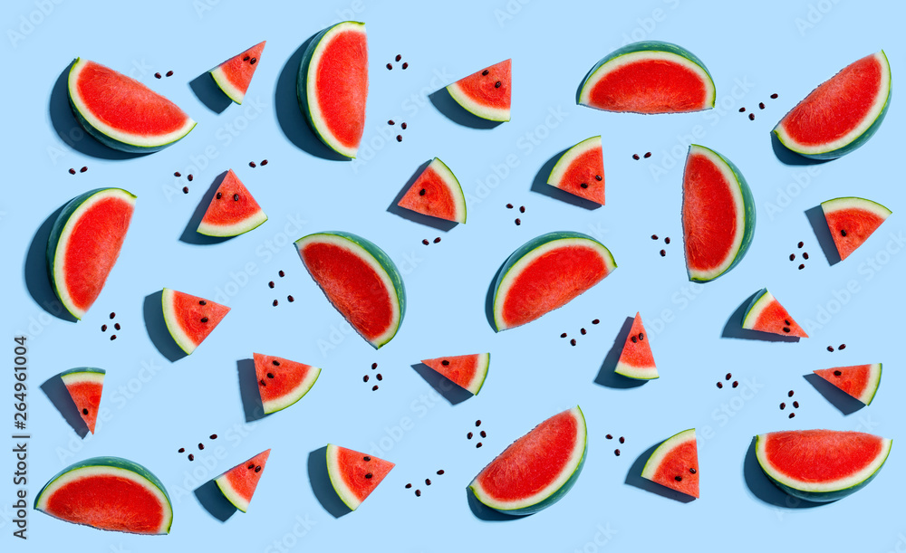 Sliced watermelons arranged on a blue background