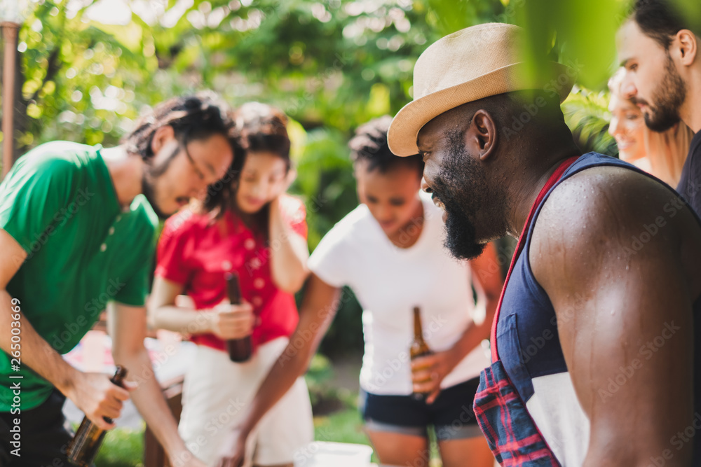 Group of diversity people having barbecue/barbeque party at home, cooking grilled meat/beef for lunc