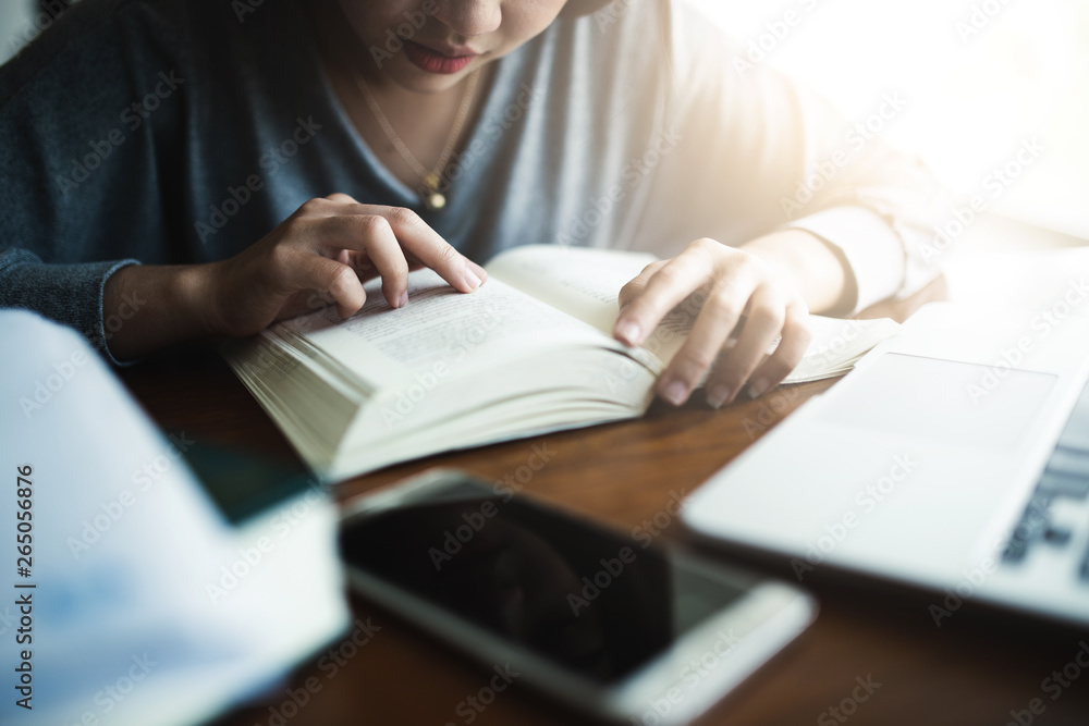 Young student reading thai book at the public library.