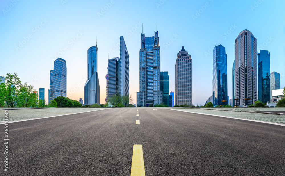 Shanghai modern commercial office buildings and straight asphalt road at night,panoramic view