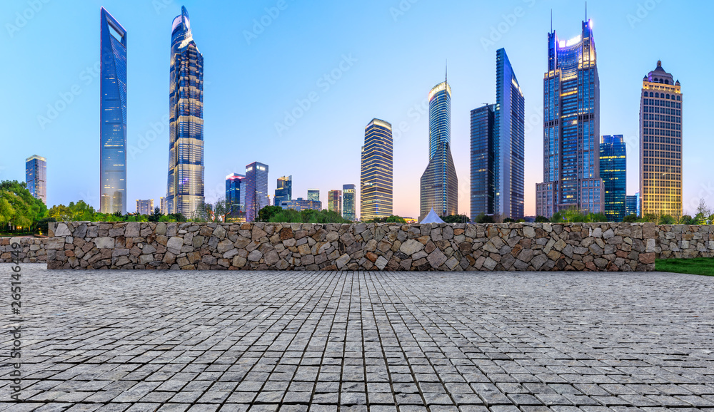 Shanghai modern commercial office buildings and stone floor at night,panoramic view