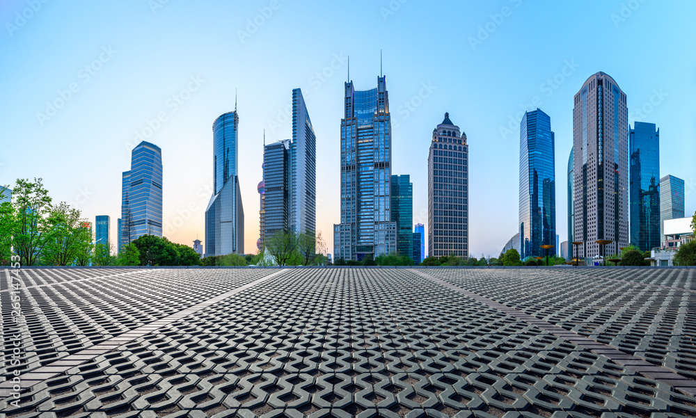 Shanghai modern commercial office buildings and square floor at dusk