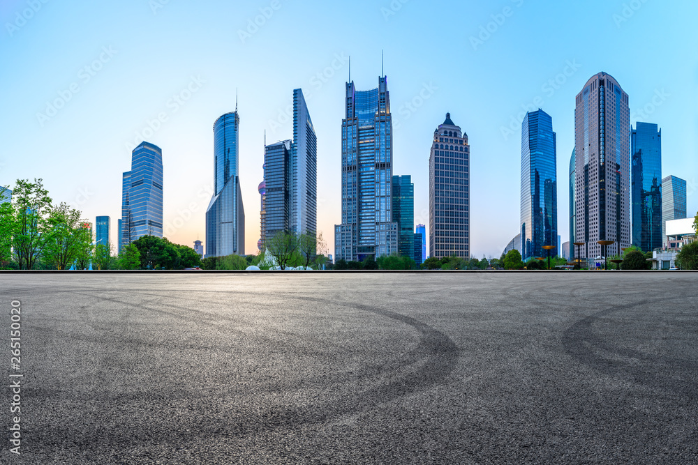 Asphalt race track ground and modern skyline and buildings in Shanghai at night,panoramic view