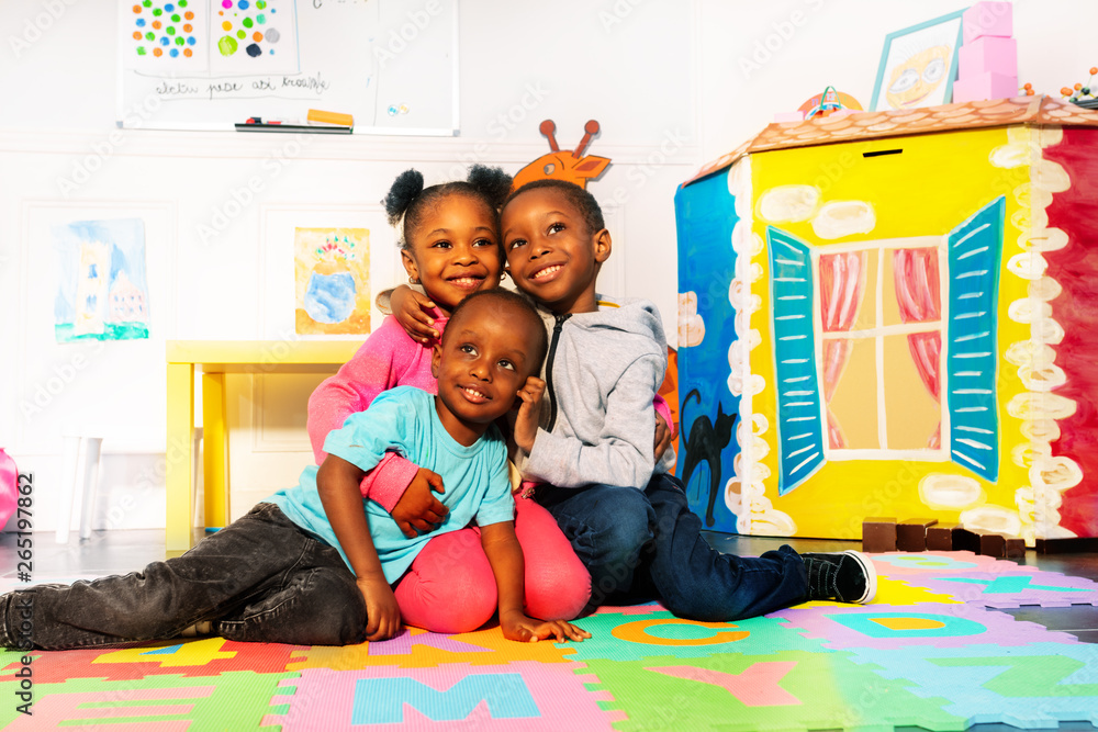 Group of kids boys and girls hug in play room