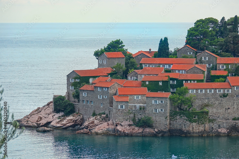 DRONE: Calm Adriatic sea surrounds the beautiful historic island in Montenegro.