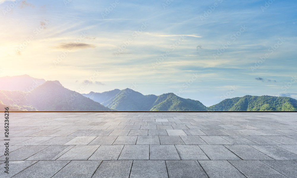 Empty square floor and green mountain natural landscape at sunset