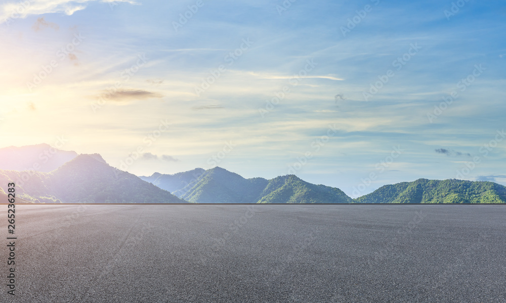 Empty asphalt race track and beautiful natural landscape at sunset