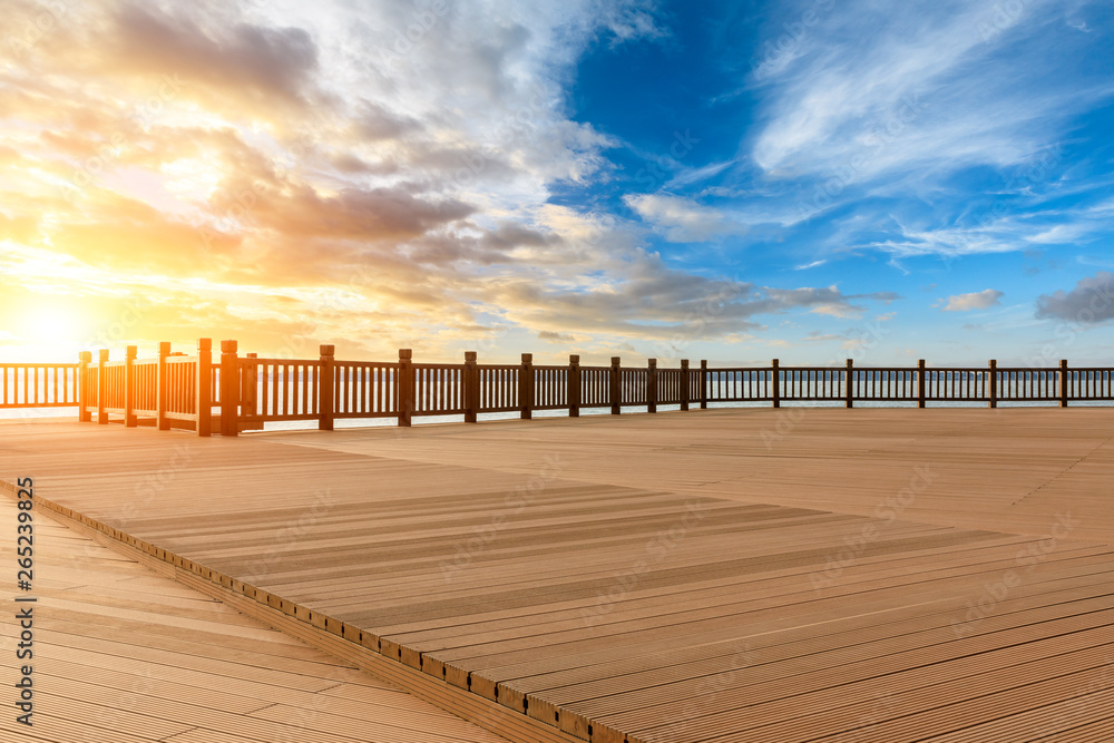 Lakeside wood floor platform and sky clouds at sunset