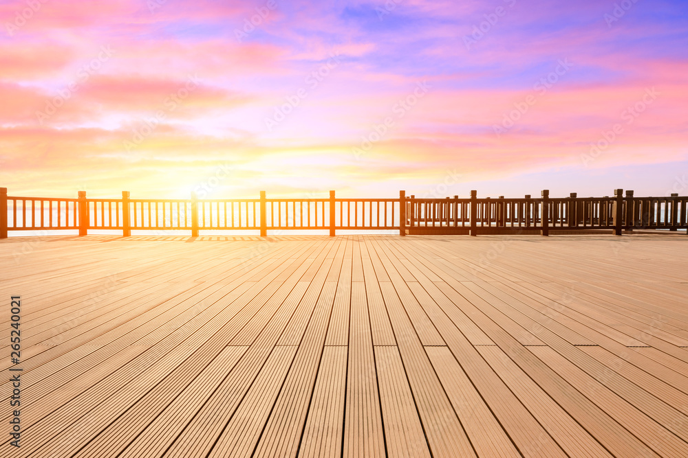 Lakeside wood floor platform and sky clouds at sunset