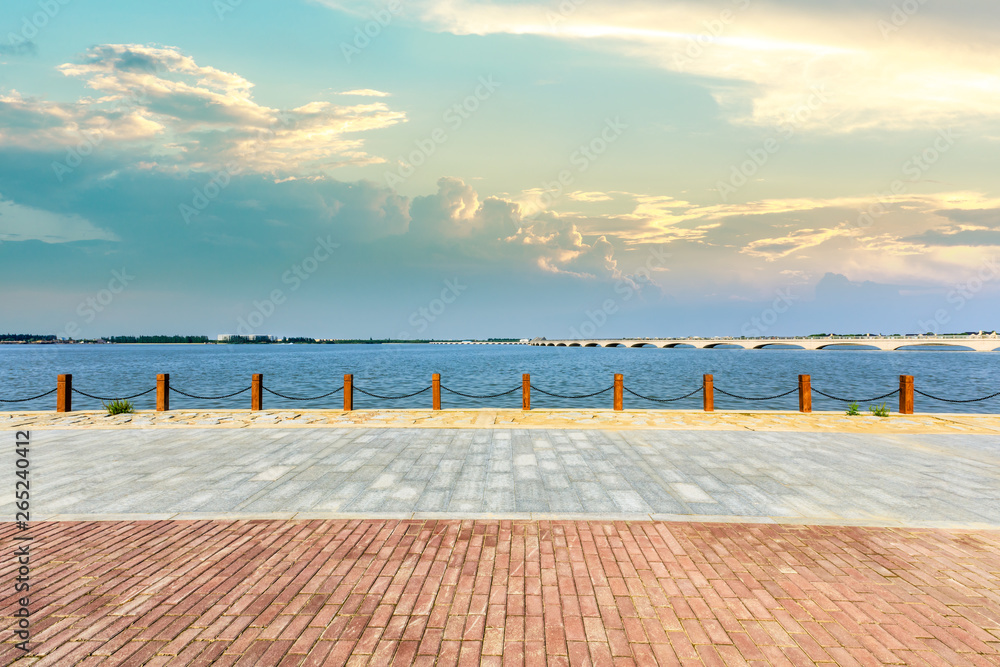 Beautiful lake and walkway with sky clouds at sunset