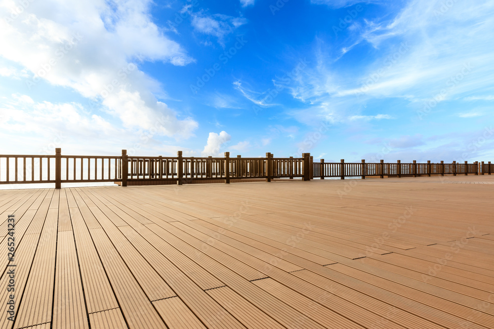 Lakeside wood floor platform and blue sky with white clouds