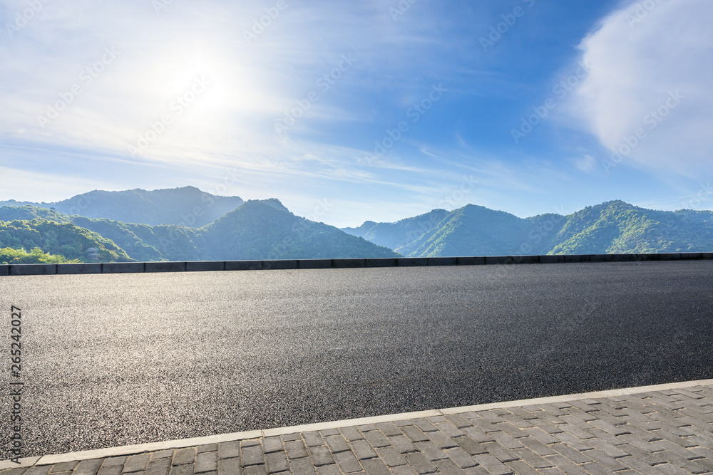 Country highway and green mountains natural landscape under the blue sky