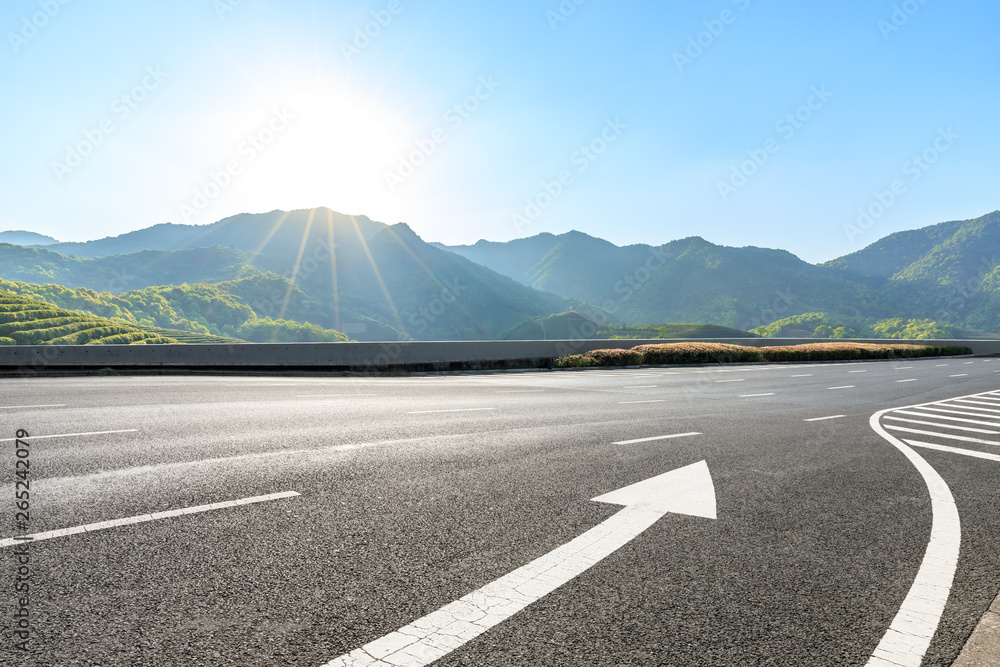 Country highway and green mountains natural landscape under the blue sky