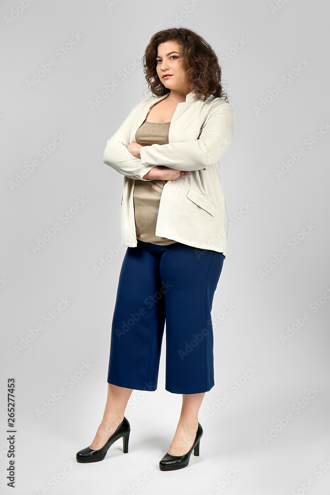 Stylish overweight woman on light background