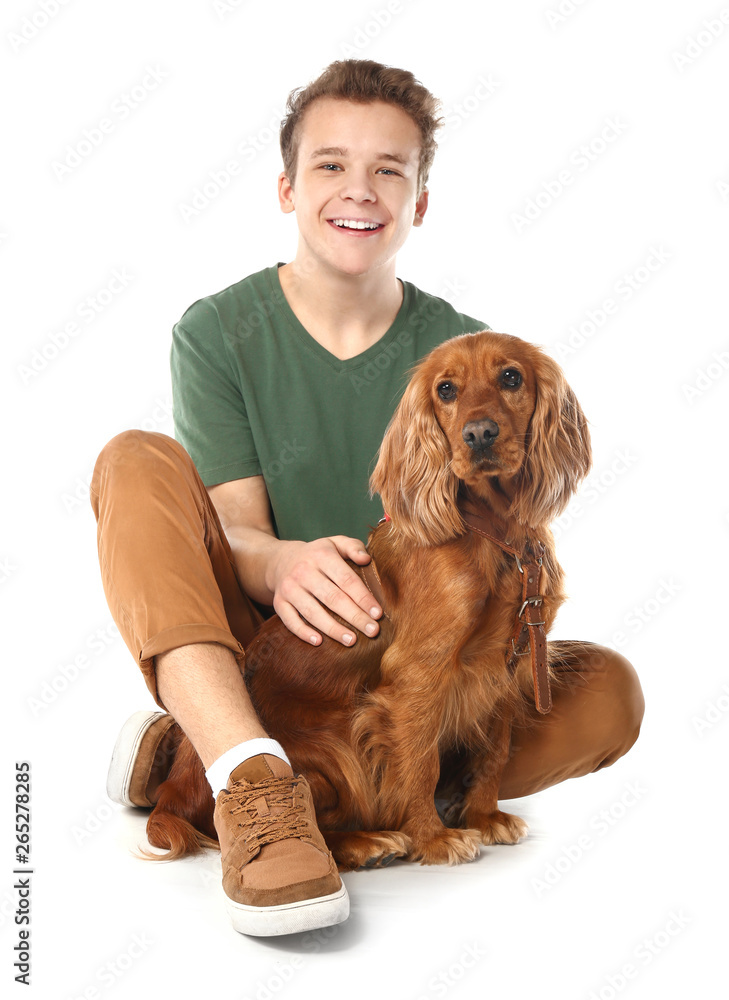 Teenage boy with cute dog on white background