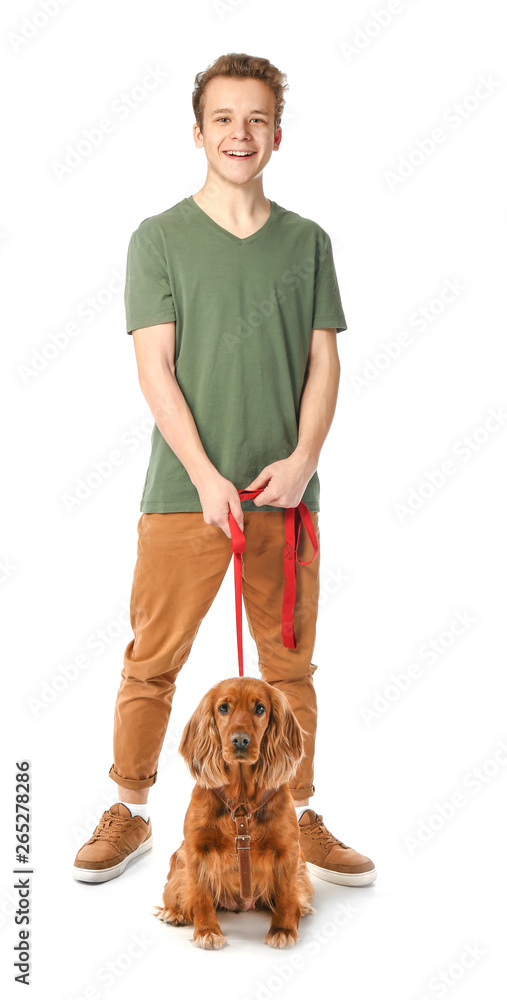 Teenage boy with cute dog on white background