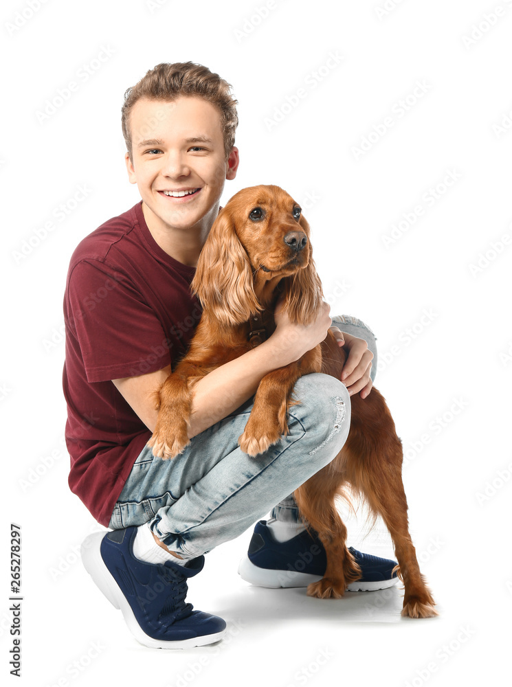 Teenage boy with cute dog on white background