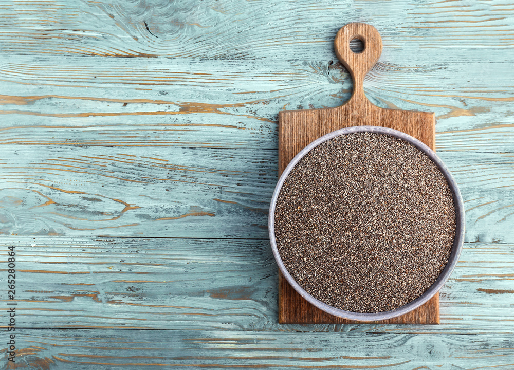 Bowl with chia seeds on wooden table