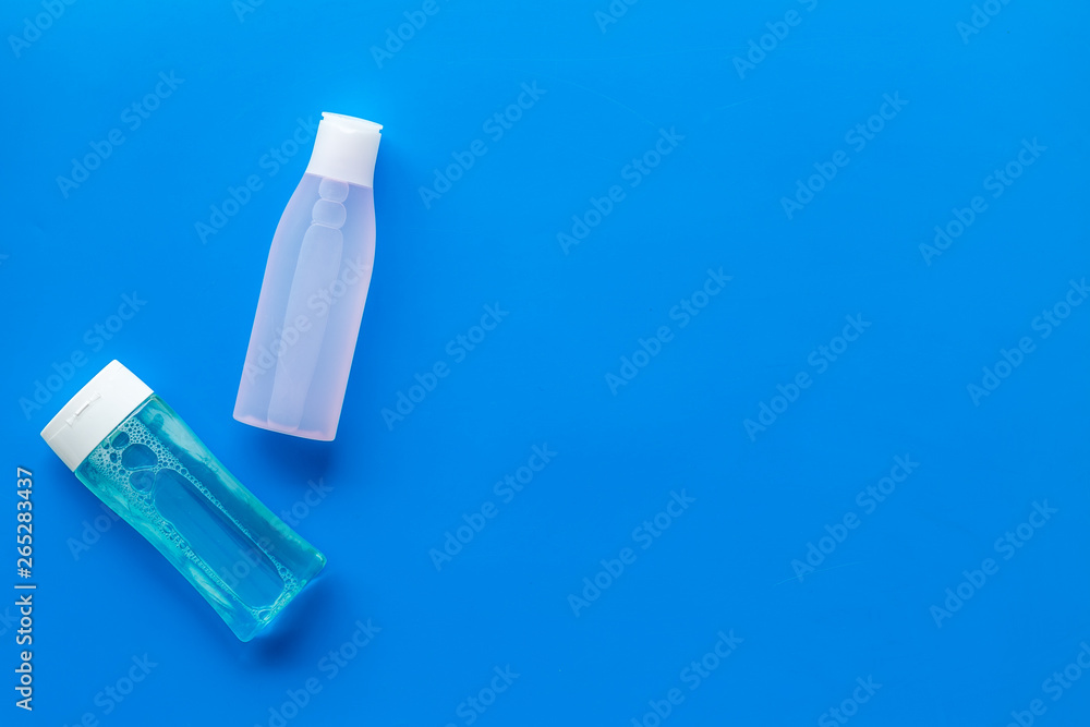 Organic cosmetics for face clearing with facial tonic and mycelial water on blue background top view