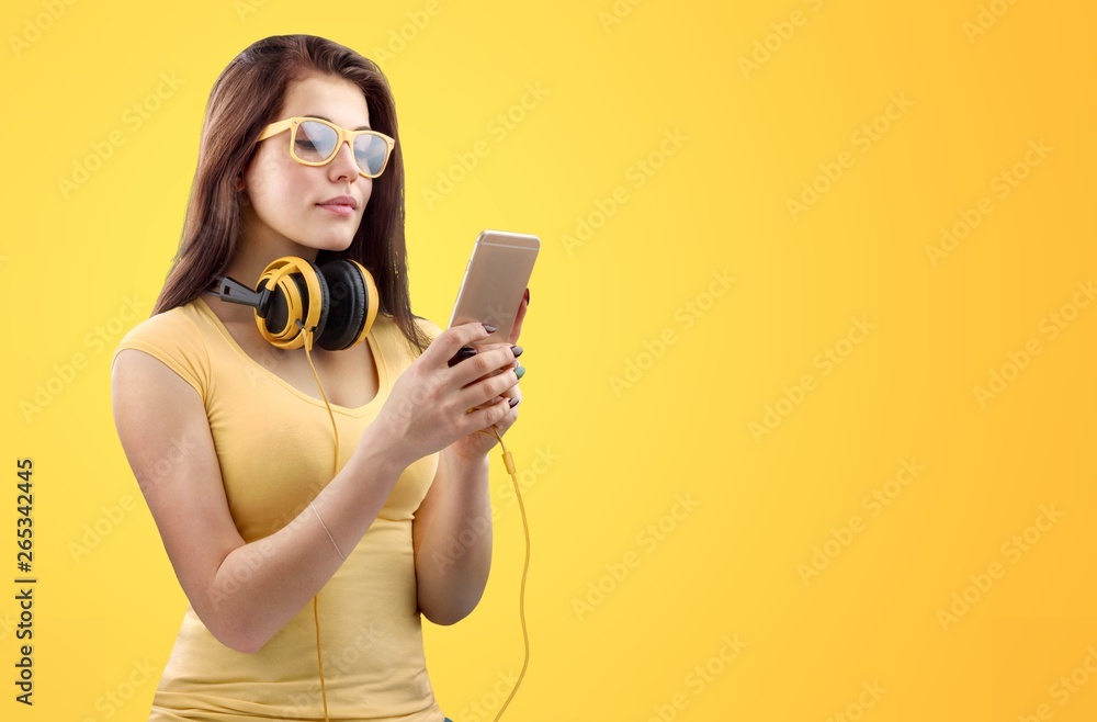 Portrait of confident young DJ with headphones on head mixing music on mixer