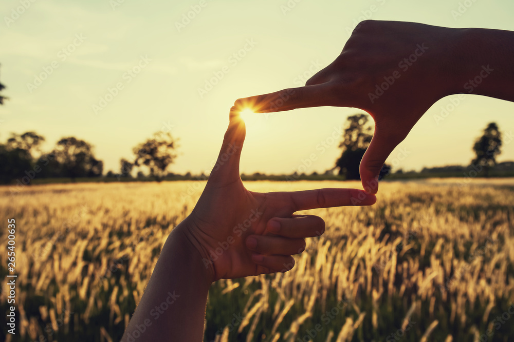 people make hand framing looking distant view sunrise. business concept