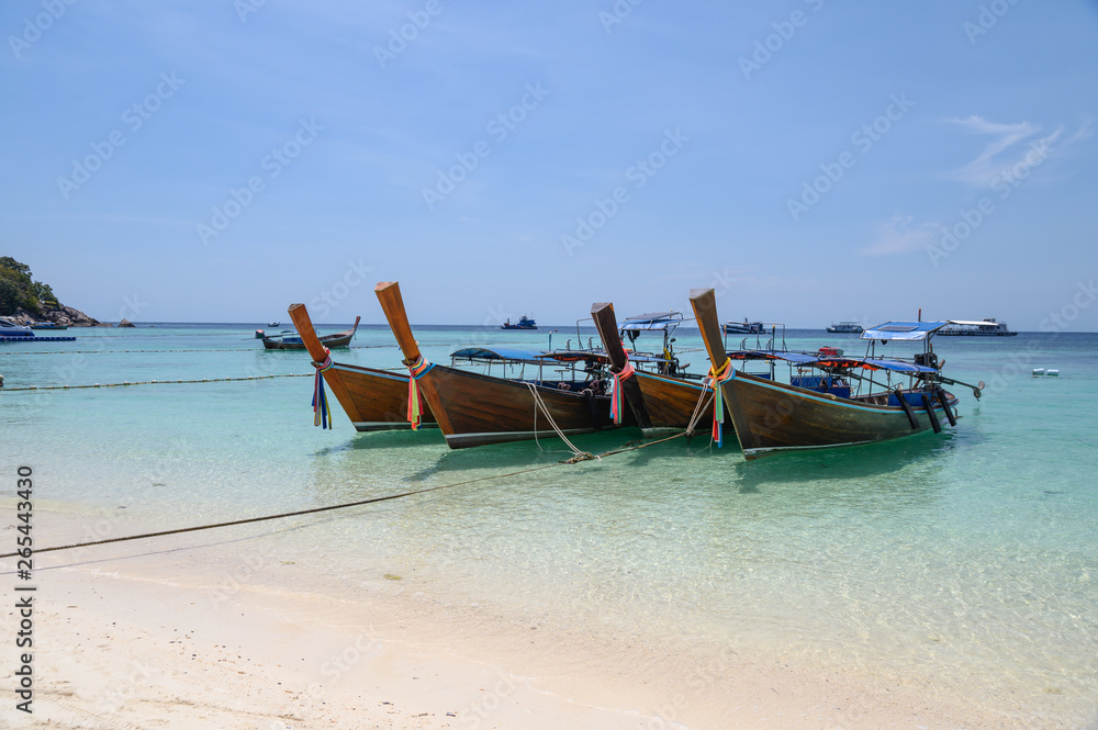 Long-tail wooden boats anchored on tropical sea in andaman