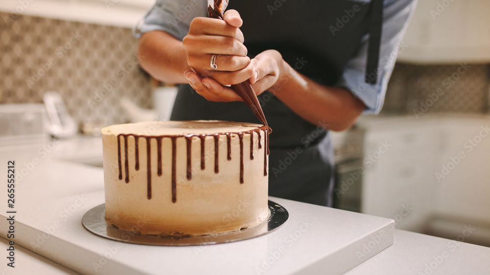 Pastry chef decorating cake