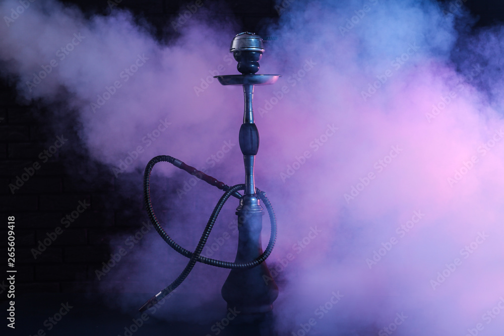 Hookah with fume on dark background