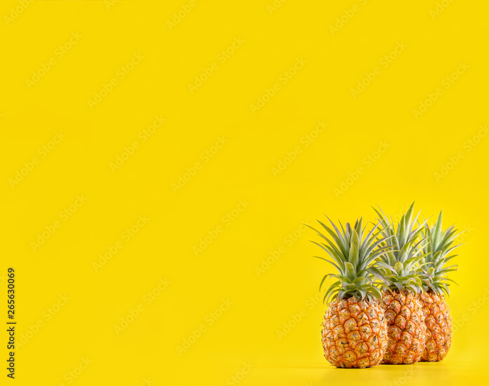 Beautiful fresh pineapple isolated on bright yellow background, summer seasonal fruit design idea pa