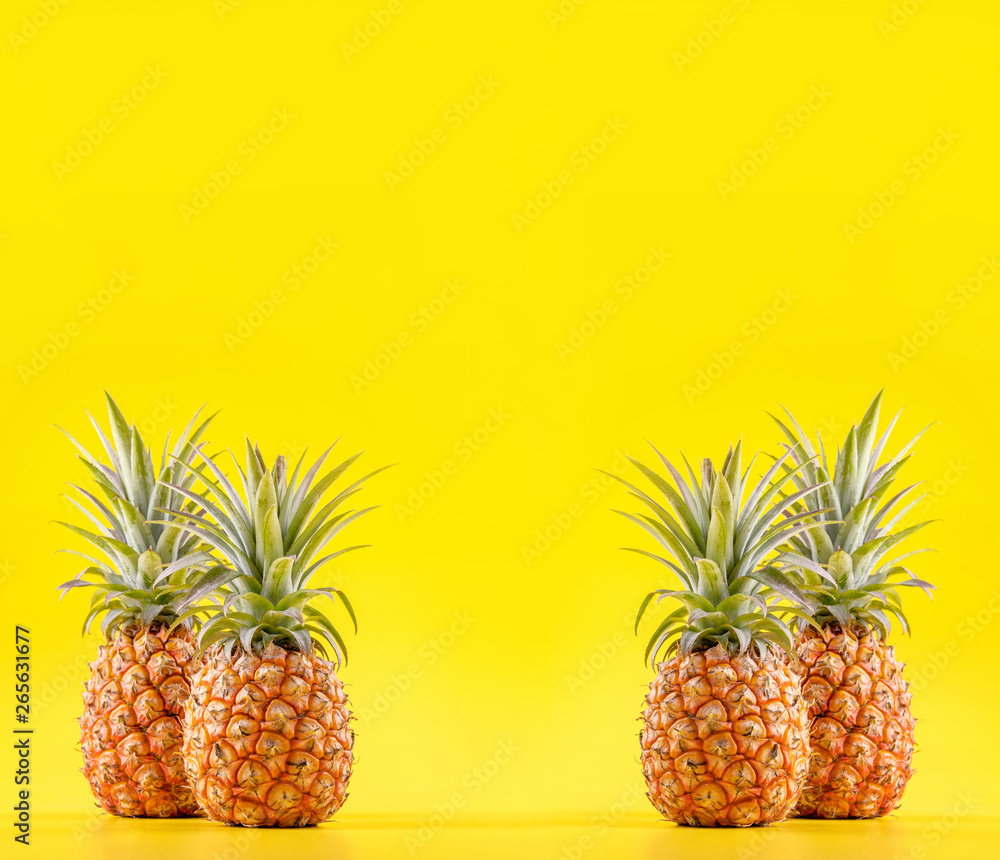 Beautiful fresh pineapple isolated on bright yellow background, summer seasonal fruit design idea pa