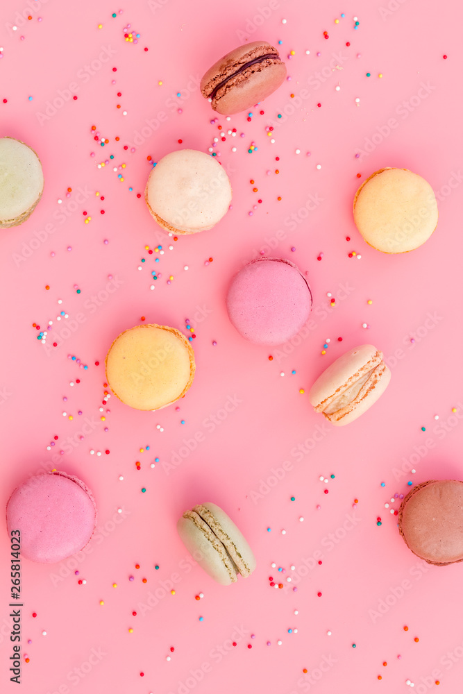 Macarons design on pink background top view pattern