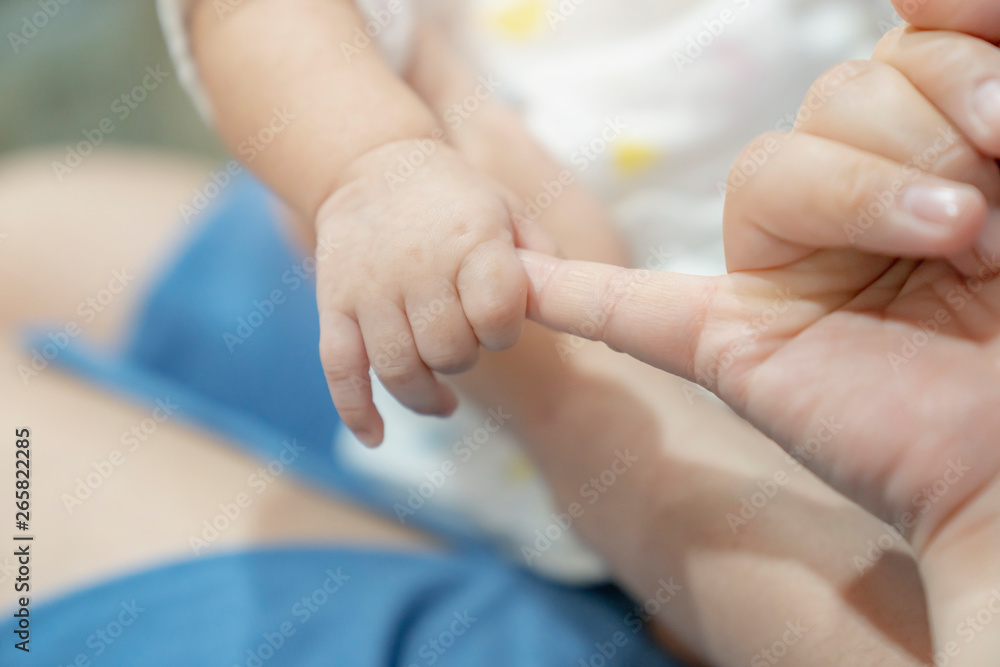 adorable asian cute baby hand hold mom finger love and care family concept