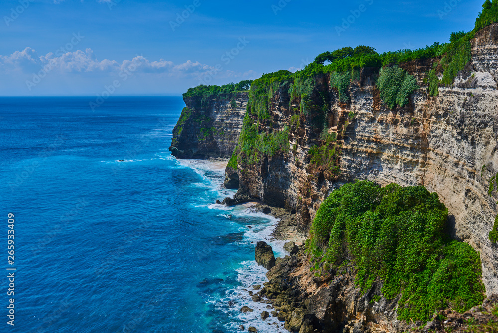 Bali seascape with huge waves and beautiful rocks. Sea beach nature, outdoor Indonesia. Island lands