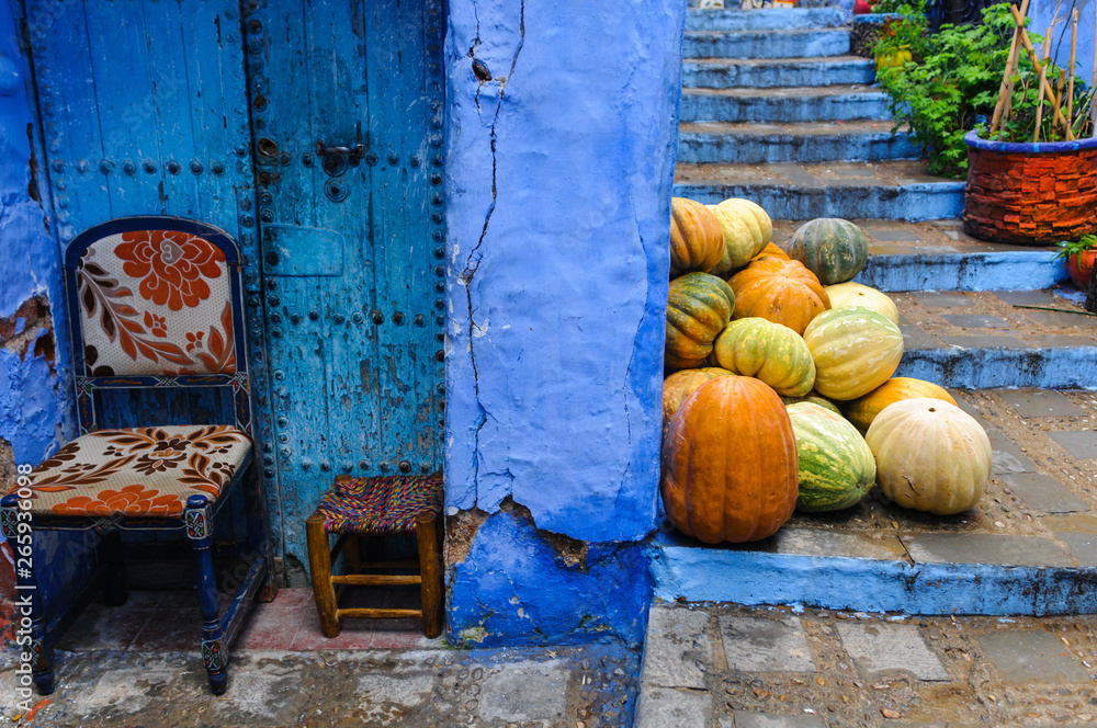 Street in the blue city Chefchaouen/Street with pumpkins in the blue city Chefchaouen, Morocco, Afri