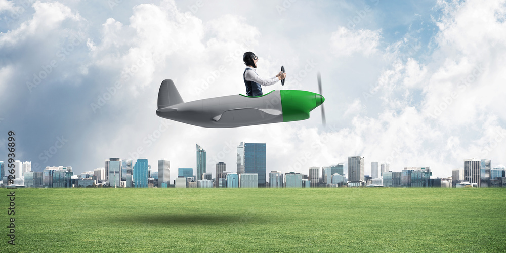 Young aviator driving small propeller plane