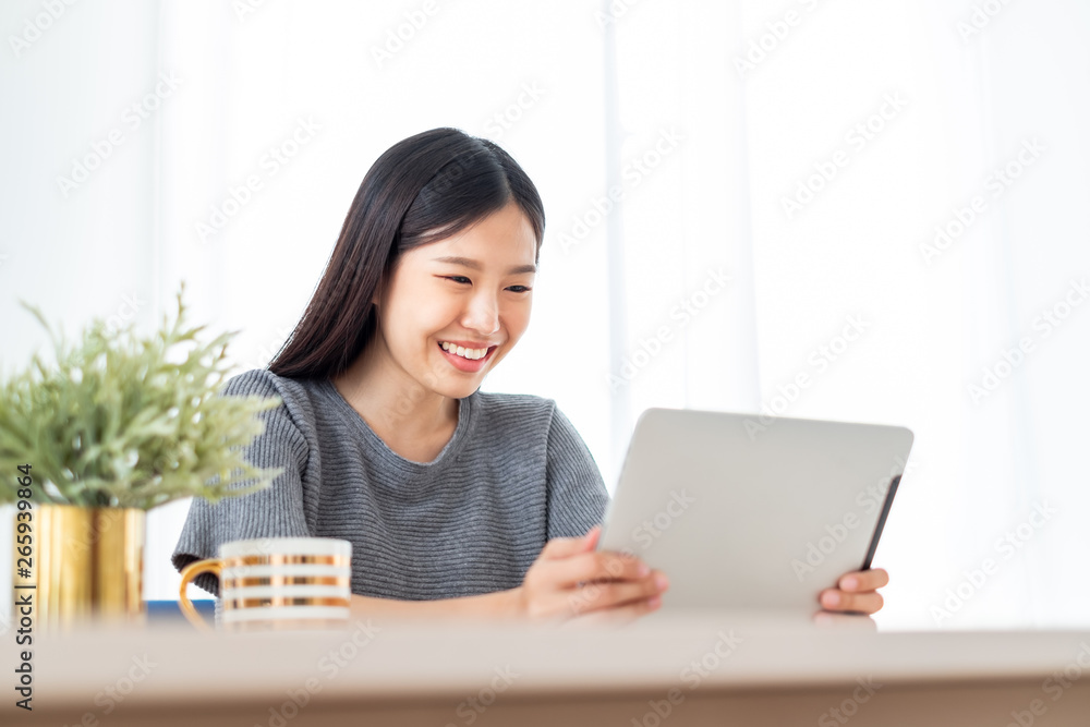 Young Asian woman using internet tablet for online shopping, lifestyle concept