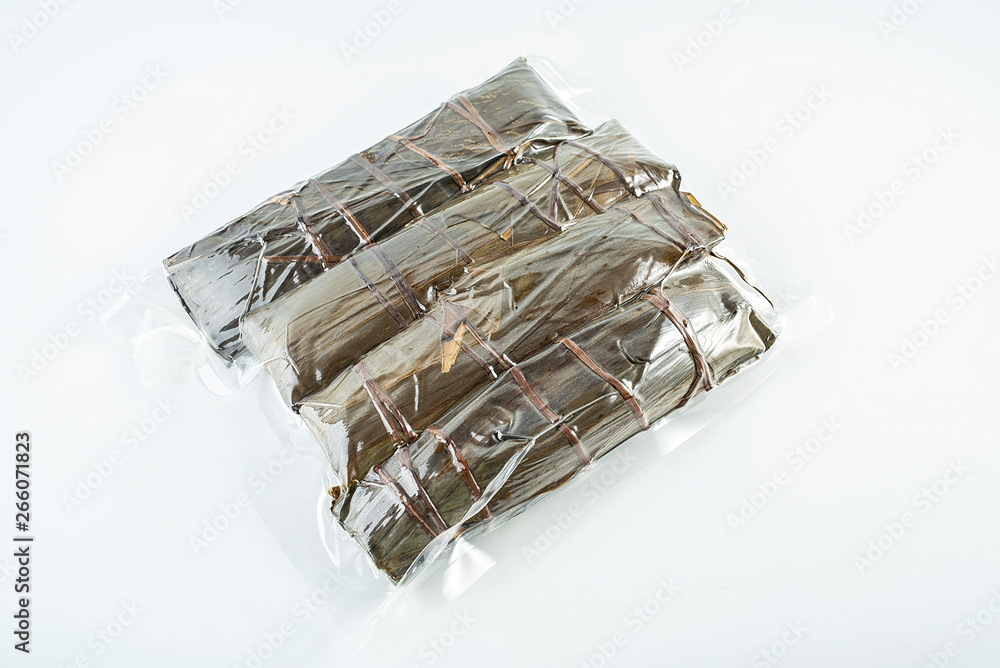 Vacuum packed hazelnuts on white background