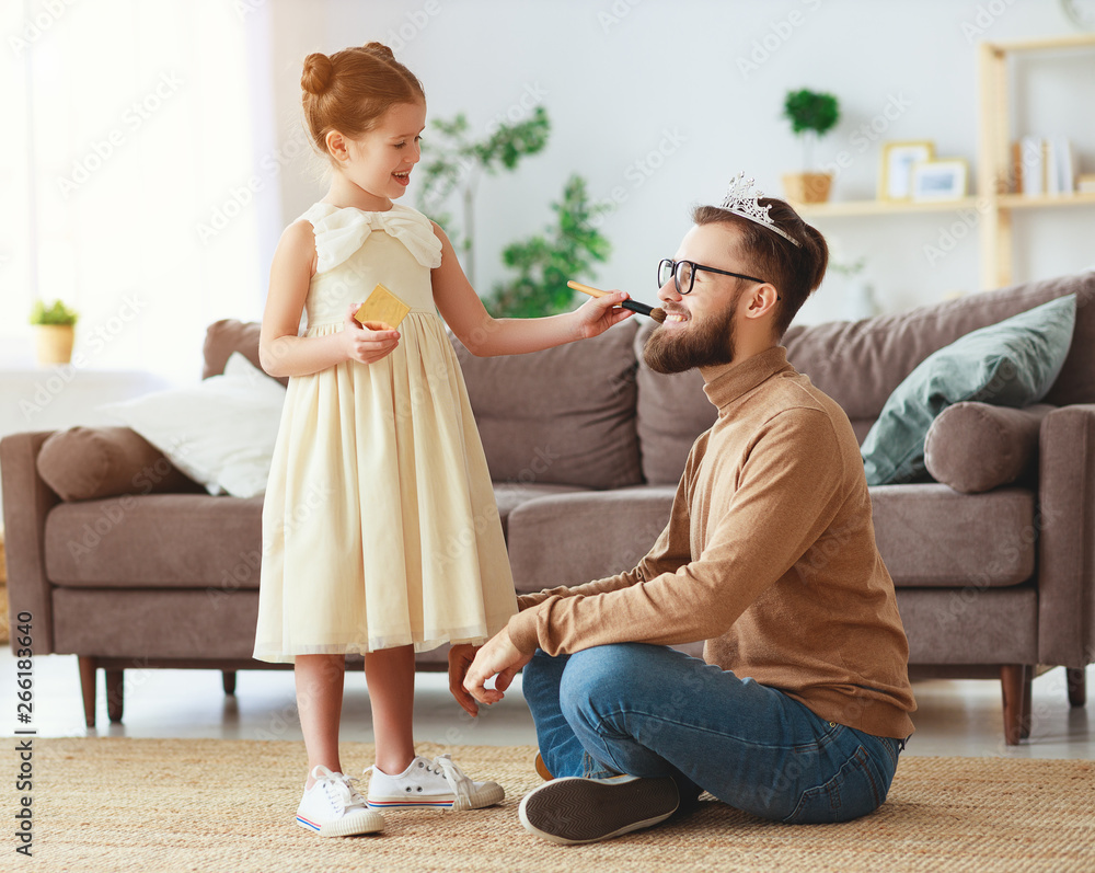 happy fathers day! child daughter in crown does makeup to daddy