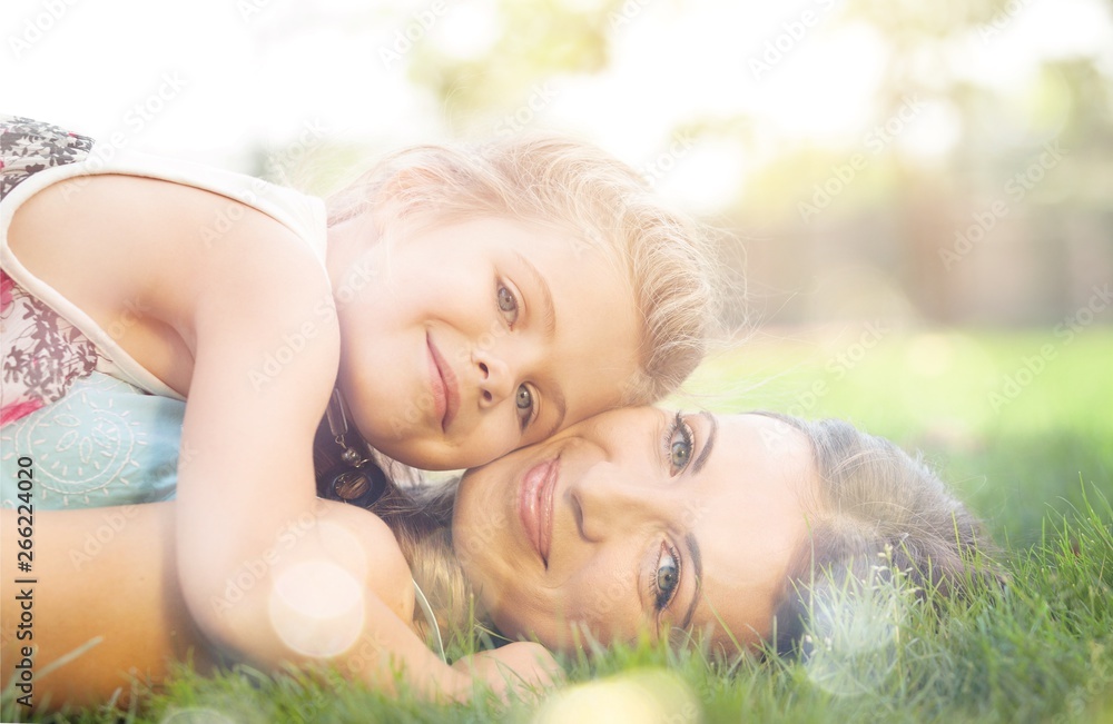 Portrait of Mother and Young Daughter Hugging in a Park