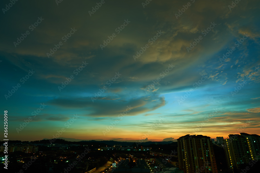 Beautiful vibrant orange cloud and blue sunset sky .