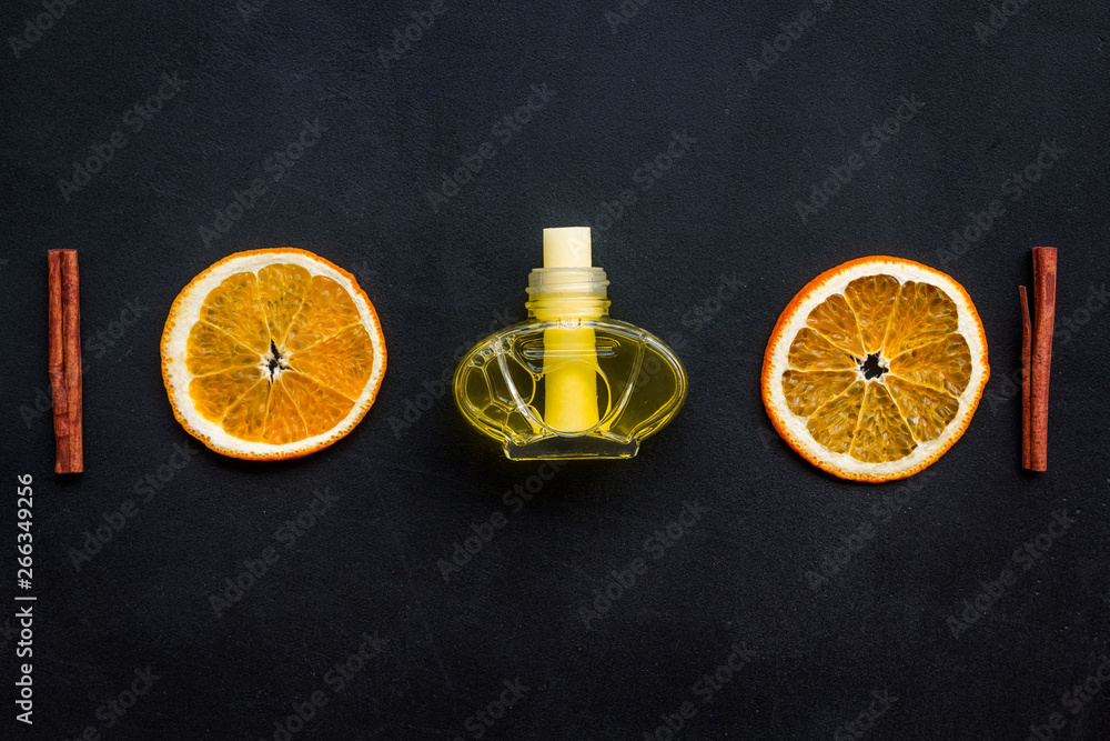 air freshener sticks with cinnamon and orange on dark background top view mockup