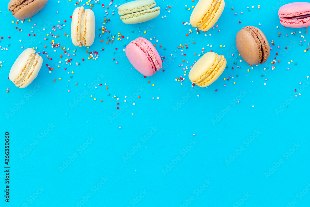 Macarons design on blue background top view space for text