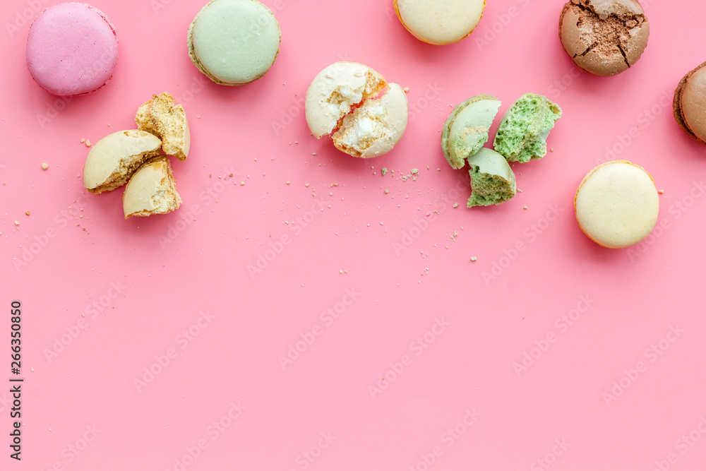 Brignt macarons for sweet break on pink background top view mock up