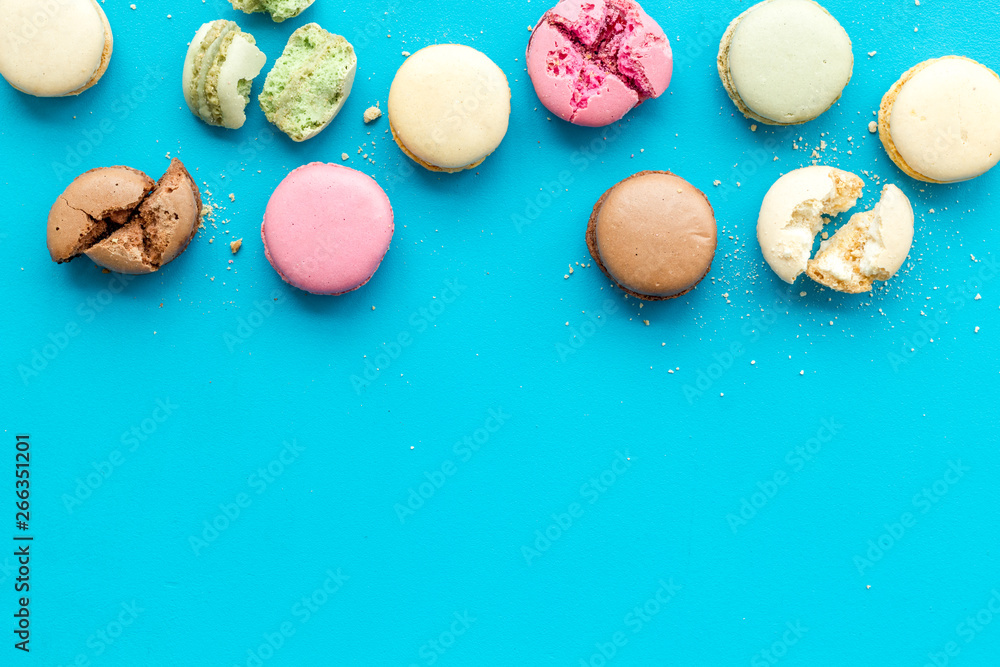 Macarons design on blue background top view space for text