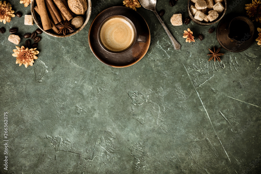 Coffee, flowers and spices on old green background