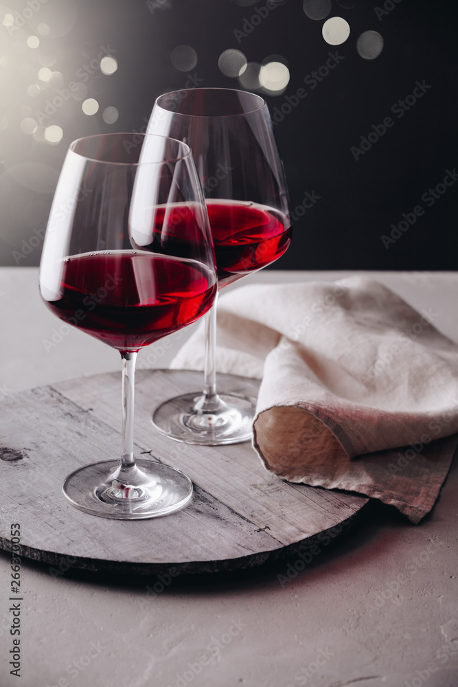 Glasses of red wine on concrete background, close up