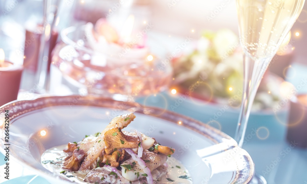 Close-up of Table with Food, Plates, Candles and Champagne Flutes