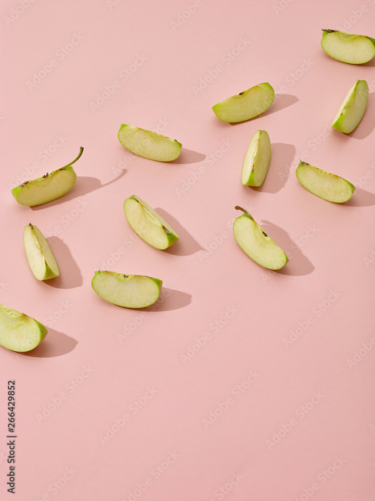 apple pieces on pink background