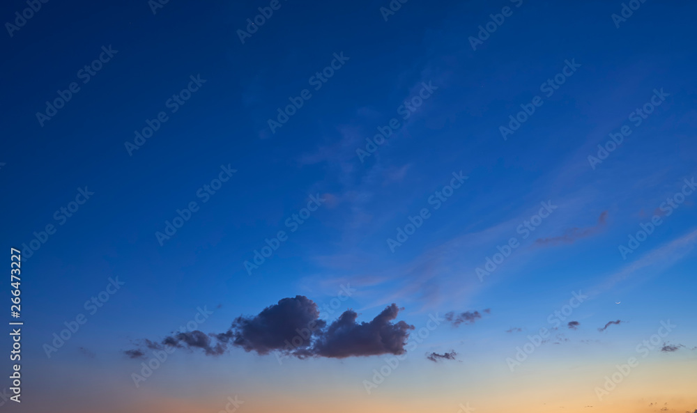 Beautiful dark blue and little warm yellow sunset sky .