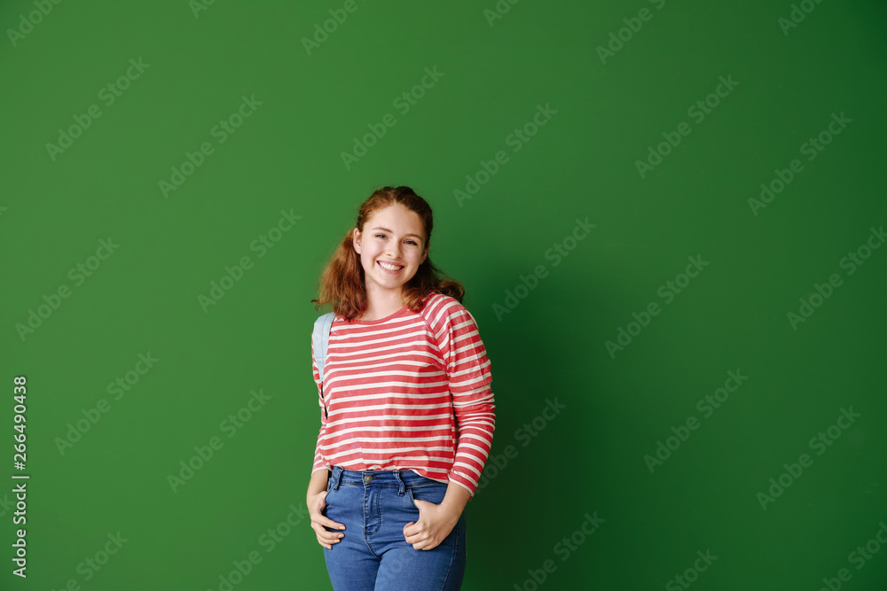 Cute teenage girl on color background